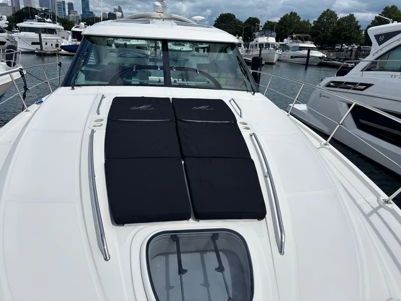 Slide: The Image of The 2012 Sea Ray 470 Sundancer is docked in a marina, featuring a sleek, modern design. - 35