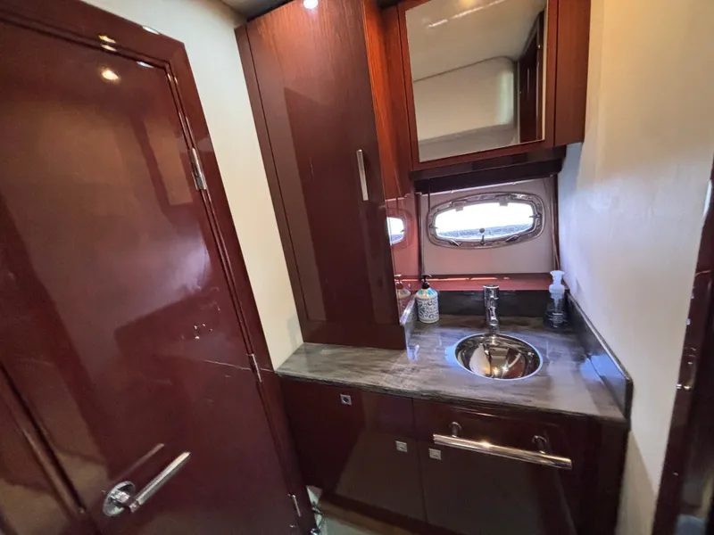Slide: The Image of The image shows an elegant bathroom with wooden cabinets, a sink, and a small window. - 26