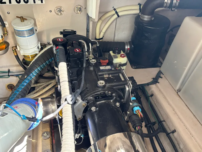 Slide: The Image of The engine room of a 2012 Sea Ray 470 Sundancer shows various hoses and components. - 32