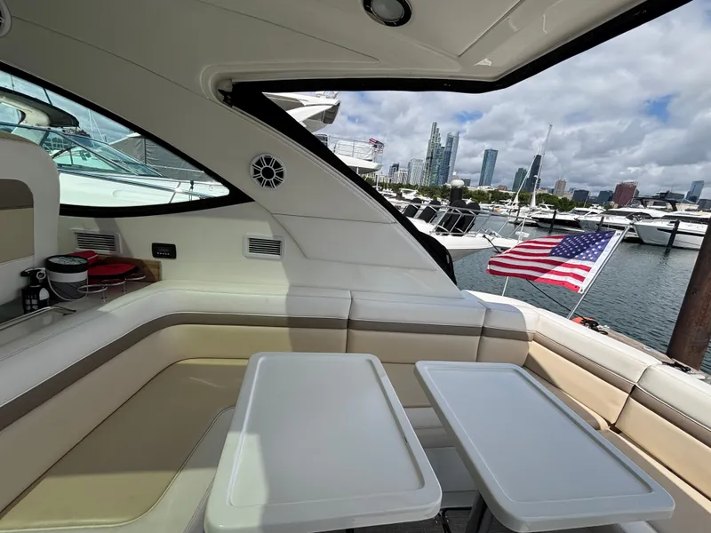 Slide: The Image of The image shows the cockpit of a 2012 Sea Ray 470 Sundancer overlooking a marina. - 4