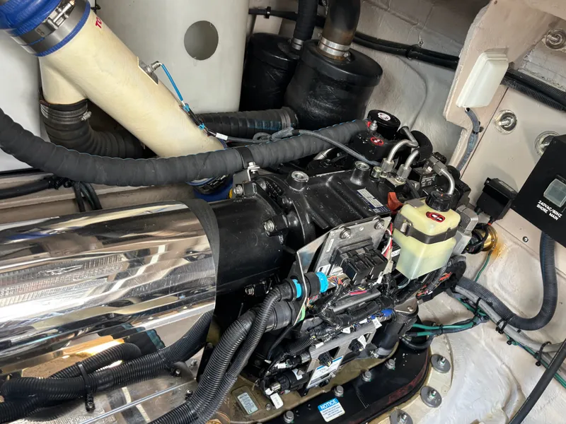 Slide: The Image of The engine room of a 2012 Sea Ray 470 Sundancer shows complex machinery and wiring. - 31
