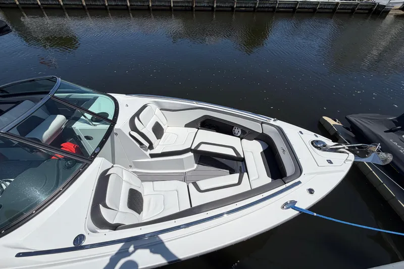 Slide: The Image of 2023 Monterey 305SS Super Sport boat with sleek seating, docked on calm water. - 45