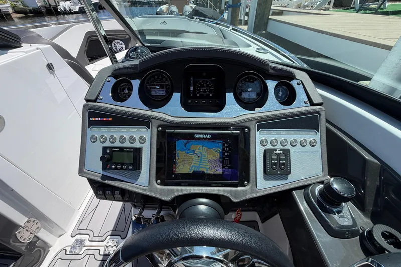 Slide: The Image of Dashboard of 2023 Monterey 305SS Super Sport boat with navigation system and controls. - 41