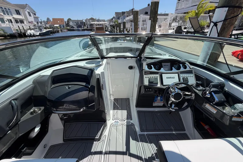 Slide: The Image of 2023 Monterey 305SS Super Sport boat interior with modern dashboard and steering wheel. - 23