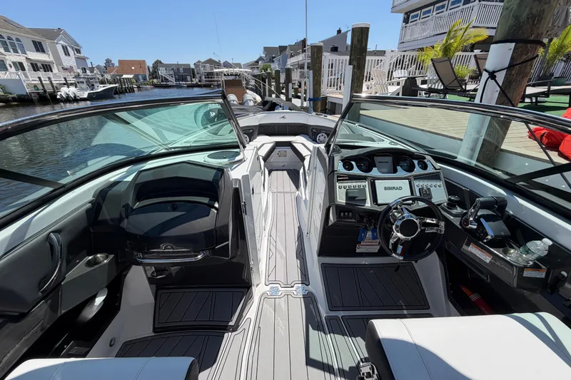 Slide: The Image of 2023 Monterey 305SS Super Sport boat interior with modern dashboard and waterfront view. - 22
