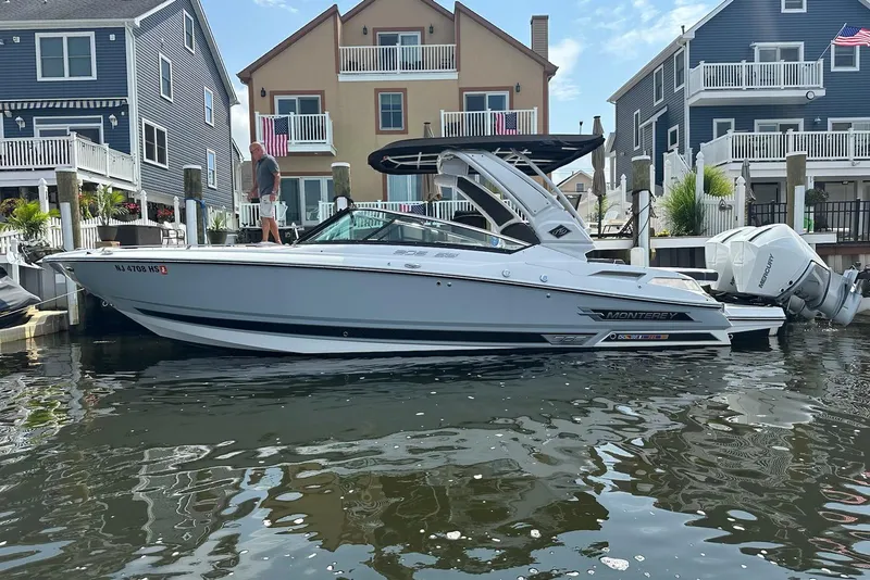 The Image of 2023 Monterey 305SS Super Sport boat docked by waterfront homes. - 10