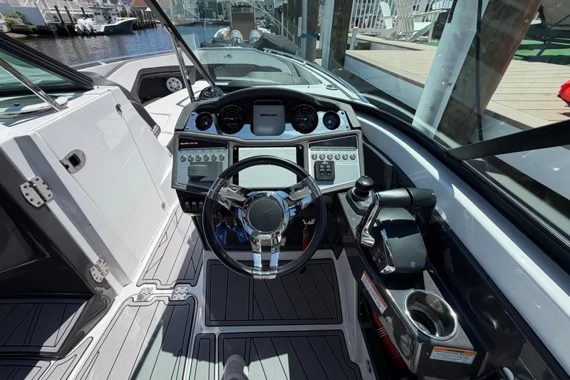 Slide: The Image of Cockpit view of 2023 Monterey 305SS Super Sport boat with modern controls and steering. - 24