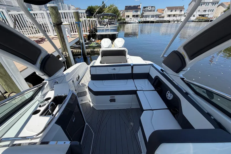 Slide: The Image of 2023 Monterey 305SS Super Sport boat interior with sleek seating and waterfront view. - 36