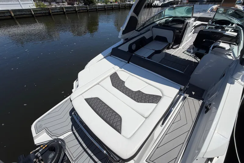 Slide: The Image of 2023 Monterey 305SS Super Sport boat with luxurious seating and sleek design by the water. - 31