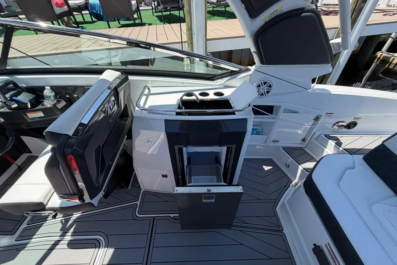 Slide: The Image of 2023 Monterey 305SS Super Sport boat interior with seating and open storage compartments. - 19