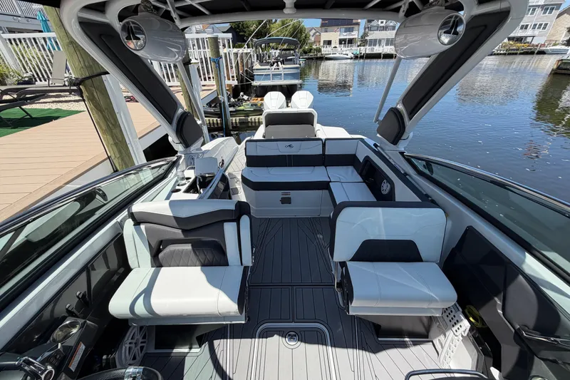 Slide: The Image of 2023 Monterey 305SS Super Sport boat interior with sleek seating and modern design. - 34