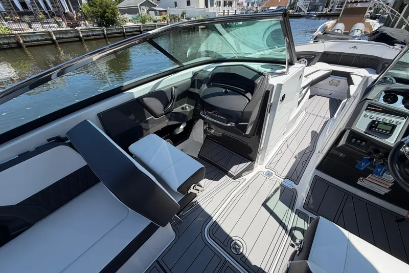 Slide: The Image of 2023 Monterey 305SS Super Sport boat interior with sleek seating and modern dashboard. - 38