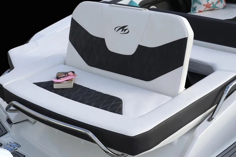 Slide: The Image of Manufacturer Provided Image: 2023 Monterey 305SS Super Sport boat seat with book and sunglasses. - 6