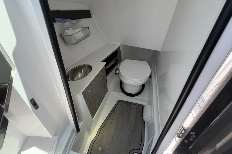 Slide: The Image of 2023 Monterey 305SS Super Sport boat bathroom with sink and toilet. - 33