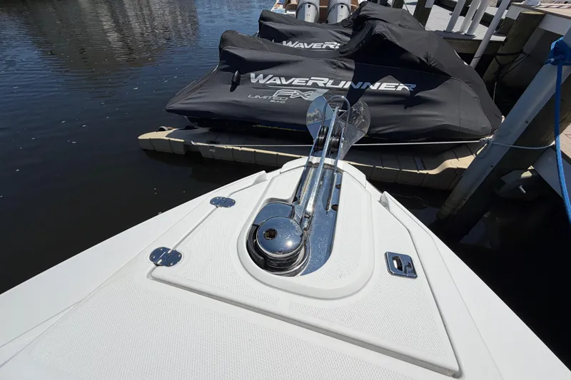 Slide: The Image of Bow of 2023 Monterey 305SS Super Sport boat with anchor, docked near jet skis. - 40