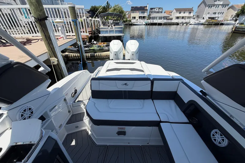 Slide: The Image of 2023 Monterey 305SS Super Sport boat interior at dock, featuring sleek seating and modern design. - 29
