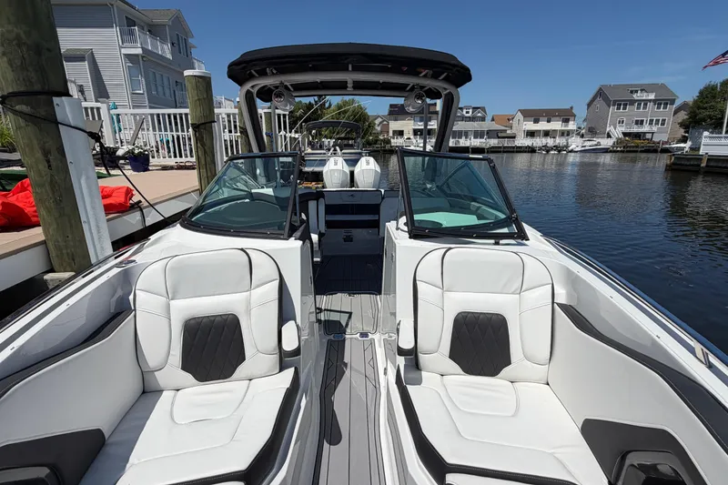 Slide: The Image of 2023 Monterey 305SS Super Sport boat docked in a scenic waterfront neighborhood. - 27