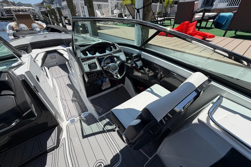 Slide: The Image of 2023 Monterey 305SS Super Sport boat interior with sleek dashboard and modern seating. - 37
