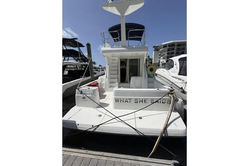 Slide: The Image of 2008 Beneteau Antares 13.80 yacht docked, rear view with name "What She Said." - 3
