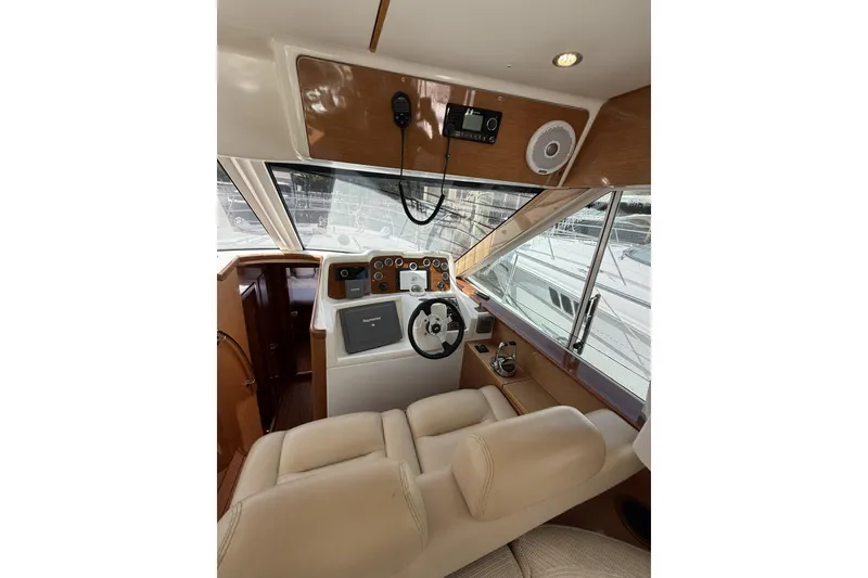 Slide: The Image of Interior helm of 2008 Beneteau Antares 13.80 yacht with modern controls and beige seating. - 16