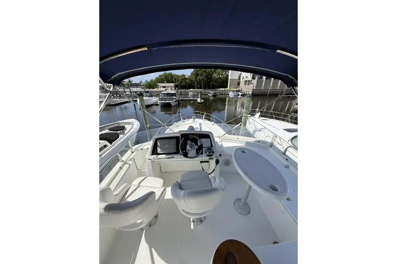 Slide: The Image of Flybridge view of 2008 Beneteau Antares 13.80 yacht docked at marina. - 9