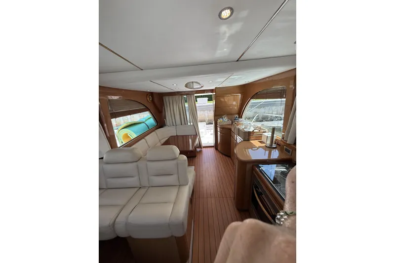 Slide: The Image of Luxurious interior of 2008 Beneteau Antares 13.80 yacht with elegant seating and wood finishes. - 18