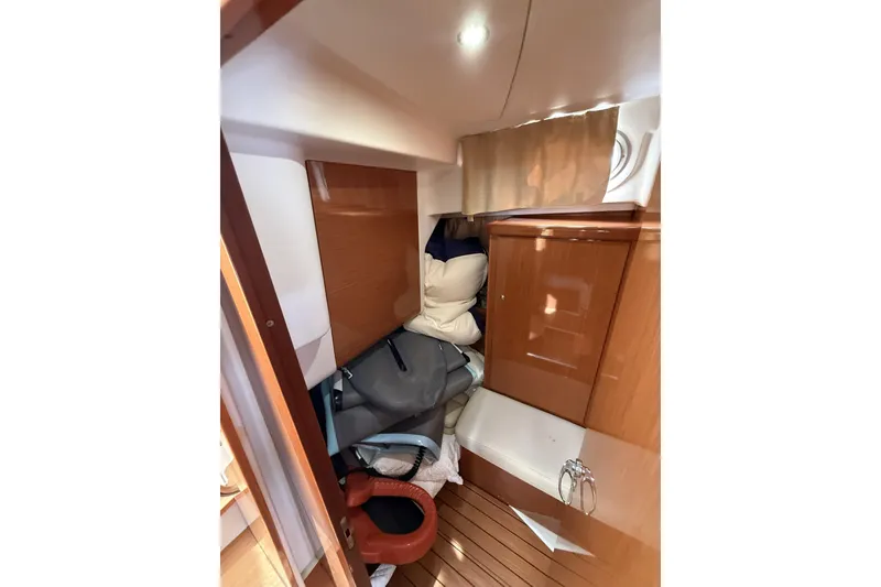 Slide: The Image of Interior cabin of 2008 Beneteau Antares 13.80 with wooden finishes and storage. - 19