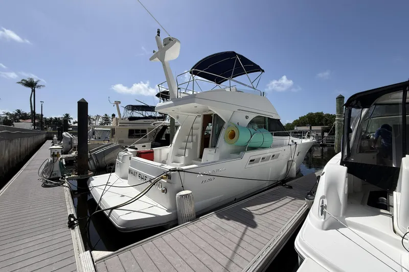 The Image of 2008 Beneteau Antares 13.80 yacht docked at marina under clear blue sky. - 1