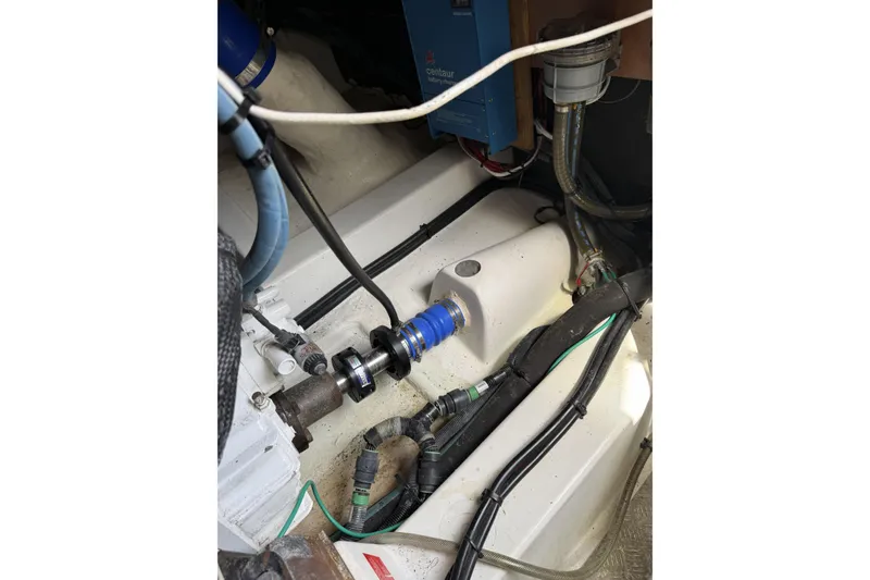 Slide: The Image of Engine compartment of a 2008 Beneteau Antares 13.80, showcasing mechanical components and wiring. - 26