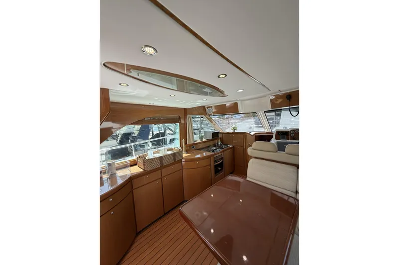 Slide: The Image of Luxurious interior of 2008 Beneteau Antares 13.80 yacht with modern kitchen and seating area. - 13