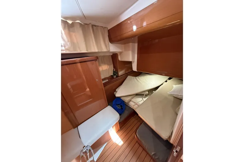 Slide: The Image of Interior cabin of 2008 Beneteau Antares 13.80 with wooden finish and cozy bedding. - 20