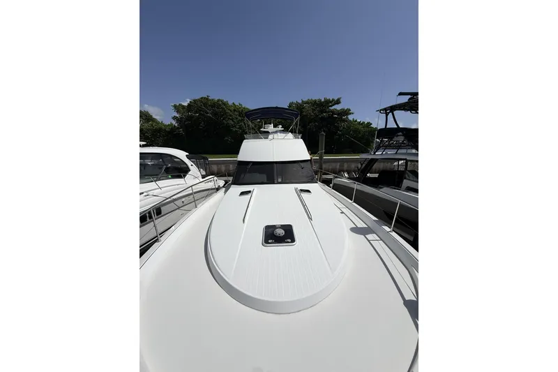 Slide: The Image of 2008 Beneteau Antares 13.80 yacht docked, showcasing sleek design and spacious deck. - 7