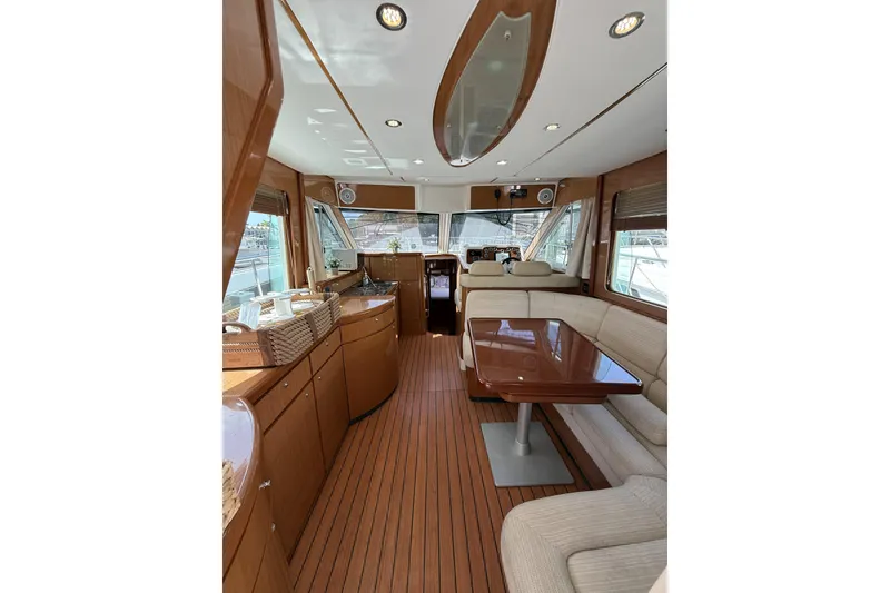 Slide: The Image of Luxurious interior of 2008 Beneteau Antares 13.80 yacht with elegant wood finishes and seating. - 12