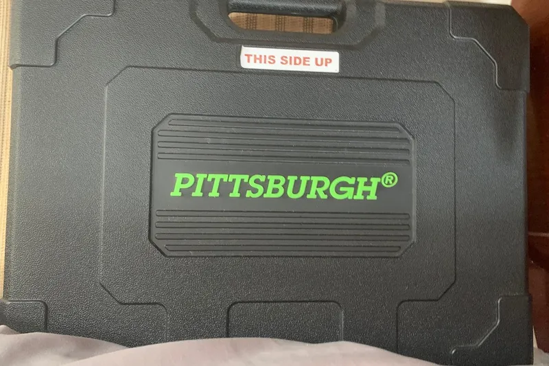 Slide: The Image of Black Pittsburgh tool case with green logo and "This Side Up" label. - 73