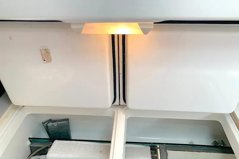Slide: The Image of Interior view of a 1990 Beneteau Oceanis 390 sailboat, featuring storage compartments. - 46