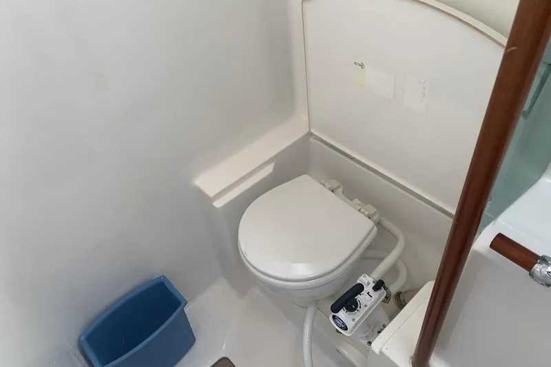 Slide: The Image of Bathroom of 1990 Beneteau Oceanis 390 yacht with marine toilet and blue waste bin. - 19