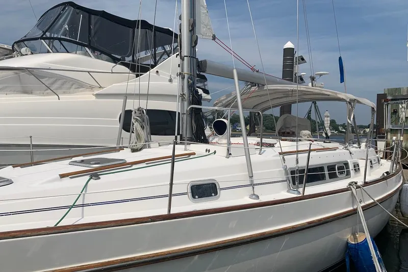 Slide: The Image of 1990 Beneteau Oceanis 390 sailboat docked at marina, featuring sleek white design. - 4