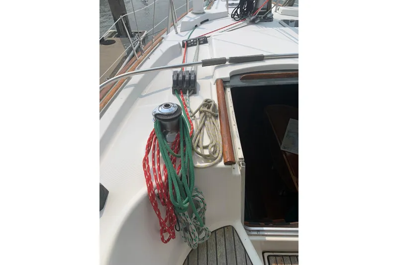 Slide: The Image of Deck of 1990 Beneteau Oceanis 390 sailboat with ropes and winch. - 60