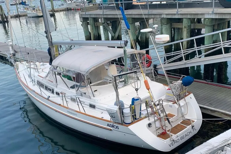The Image of 1996 Beneteau Oceanis 40 CC sailboat docked with inflatable dinghy nearby. - 0