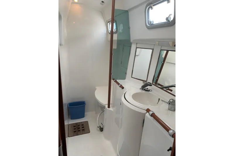 Slide: The Image of Bathroom interior of 1990 Beneteau Oceanis 390 yacht, featuring sink and mirror. - 21