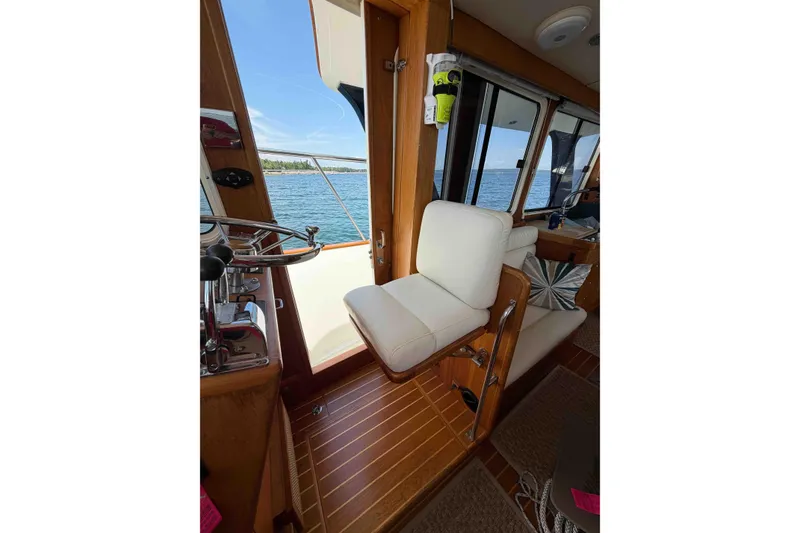 Slide: The Image of Interior of 2003 Pacific Seacraft 38T Fast Trawler with helm and seating, overlooking water. - 106