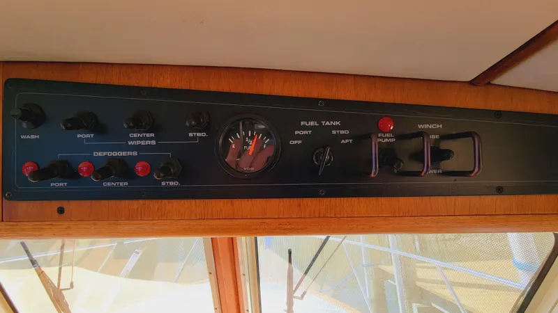 Slide: The Image of The dashboard of a 2003 Pacific Seacraft 38T Fast Trawler with various switches and gauges. - 45