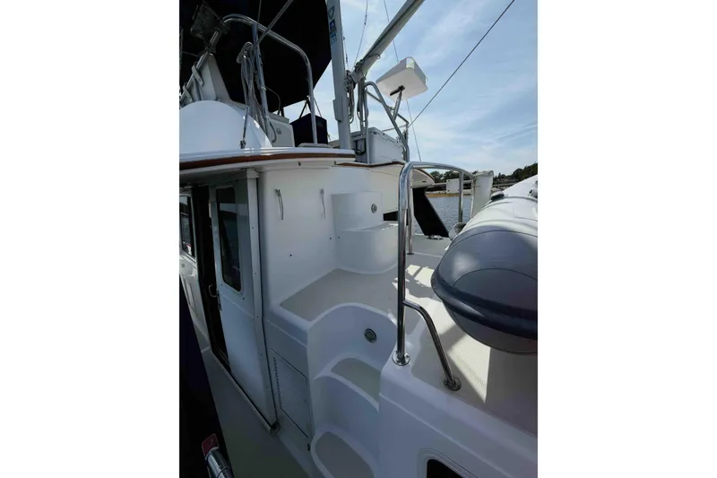 Slide: The Image of 2003 Pacific Seacraft 38T Fast Trawler deck with railing and inflatable boat. - 114