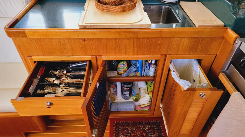 Slide: The Image of The galley of a 2003 Pacific Seacraft 38T Fast Trawler with wooden cabinets and a sink. - 22