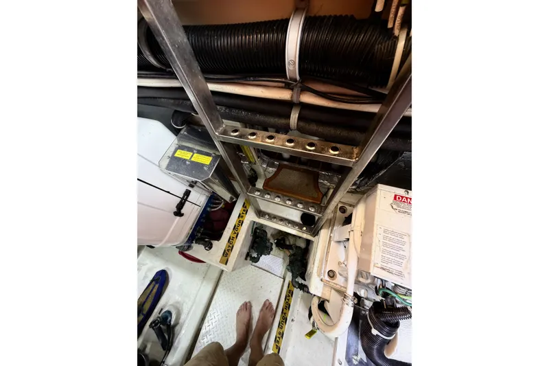 Slide: The Image of Engine room of a 2003 Pacific Seacraft 38T Fast Trawler with visible ladder and equipment. - 157