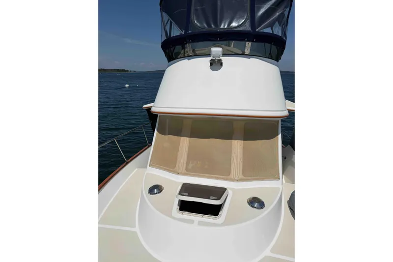 Slide: The Image of 2003 Pacific Seacraft 38T Fast Trawler on calm water, showcasing deck and cabin details. - 107