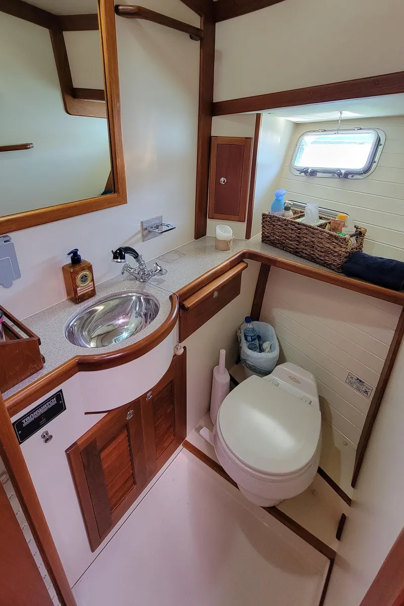 Slide: The Image of Bathroom in a 2003 Pacific Seacraft 38T Fast Trawler with sink, toilet, and mirror. - 35