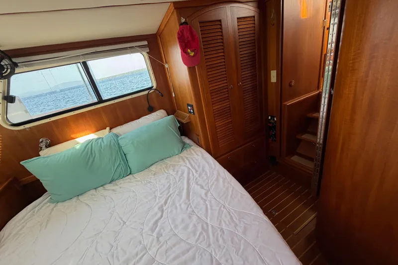Slide: The Image of Cozy cabin interior of 2003 Pacific Seacraft 38T Fast Trawler with bed and wooden furnishings. - 130