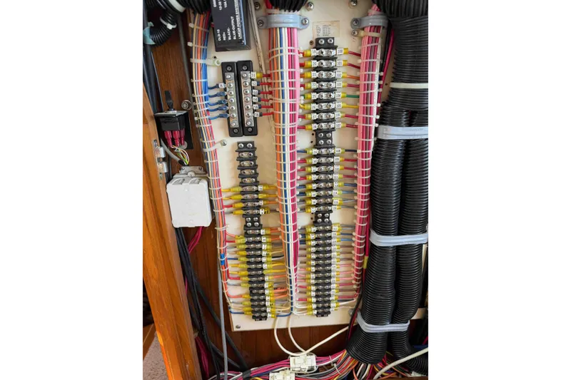 Slide: The Image of Electrical panel with organized wiring in a 2003 Pacific Seacraft 38T Fast Trawler. - 93