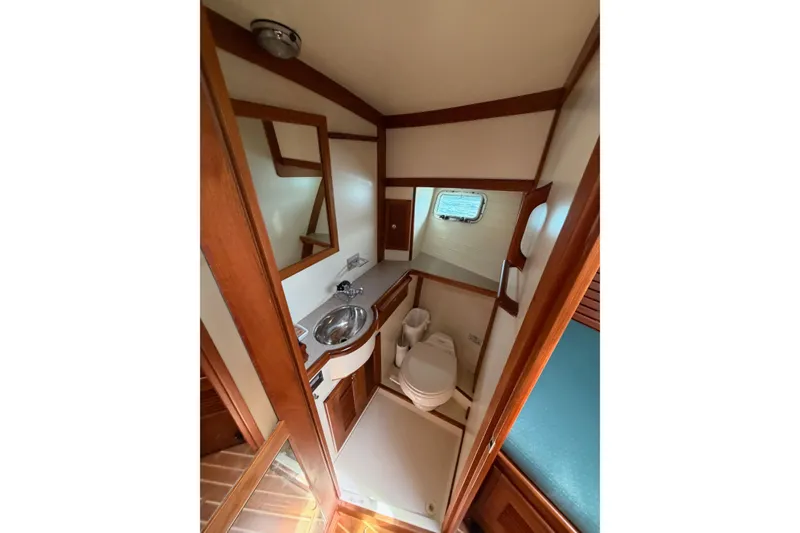 Slide: The Image of Bathroom interior of 2003 Pacific Seacraft 38T Fast Trawler with wooden accents and compact design. - 111